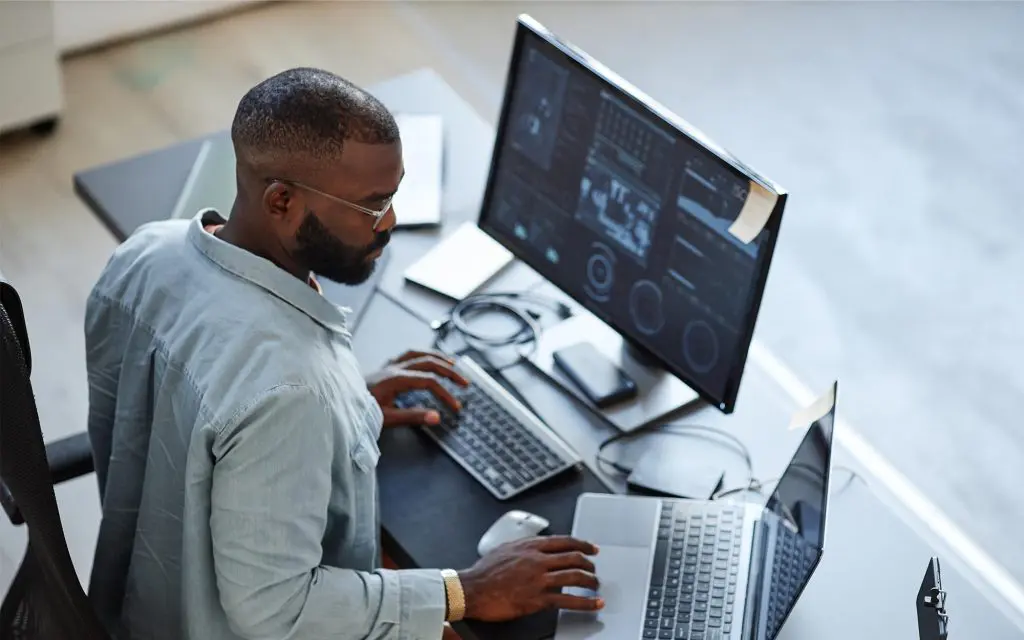 Tech professional reviewing information on computer